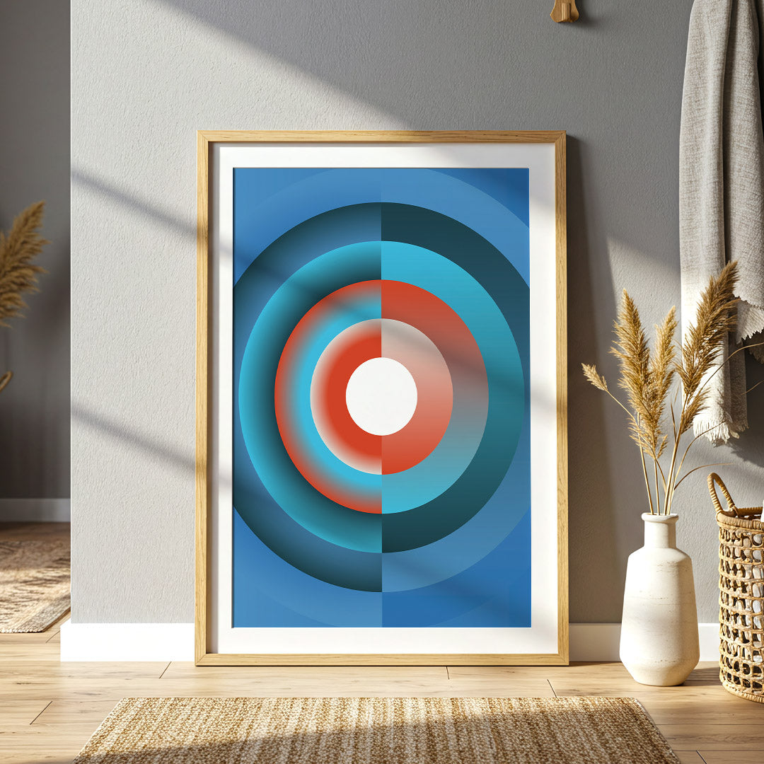 Framed abstract art with concentric circles in blue, red, and white on a wall.