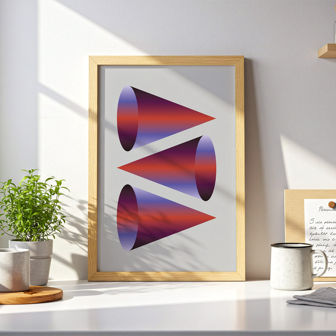 Framed abstract art piece on a desk with plants and a mug.