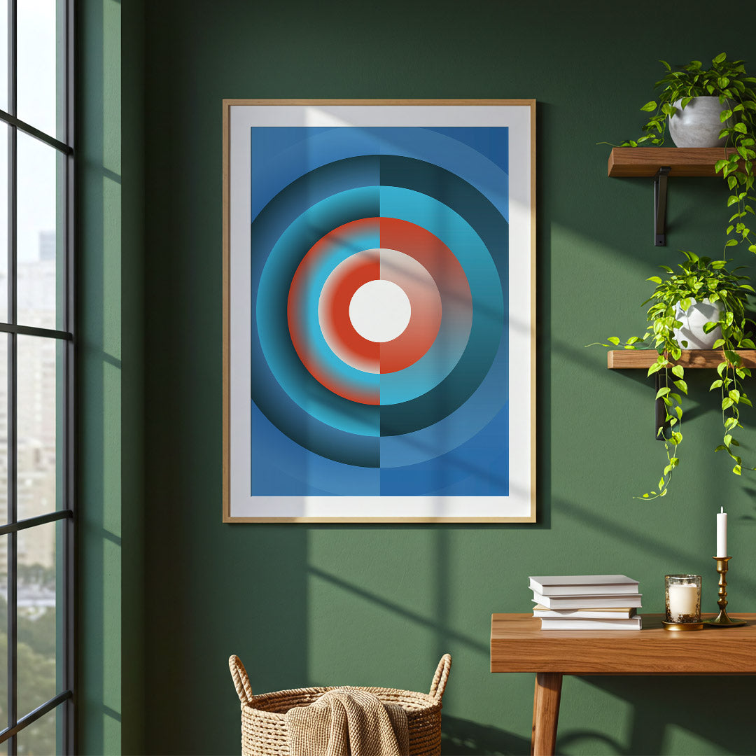 Framed abstract art piece on a green wall with a desk and window in the background