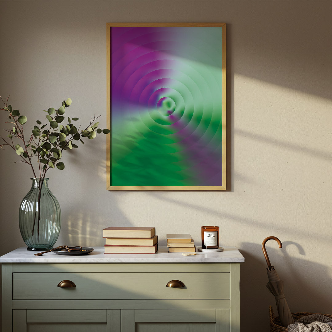 Framed abstract artwork on a wall above a dresser with decorative items.